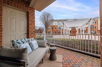 Private balcony with sofa and brick pavers